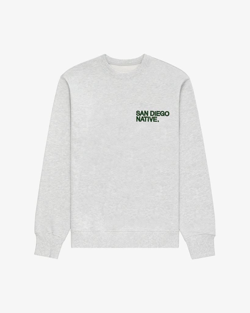 Front view of The SDN. Brand Souvenir Crew — heavyweight French terry pullover with puff-embroidered stacked logo on chest.