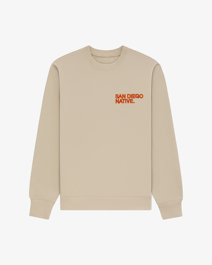 Front view of The SDN. Brand Souvenir Crew — heavyweight French terry pullover with puff-embroidered stacked logo on chest.